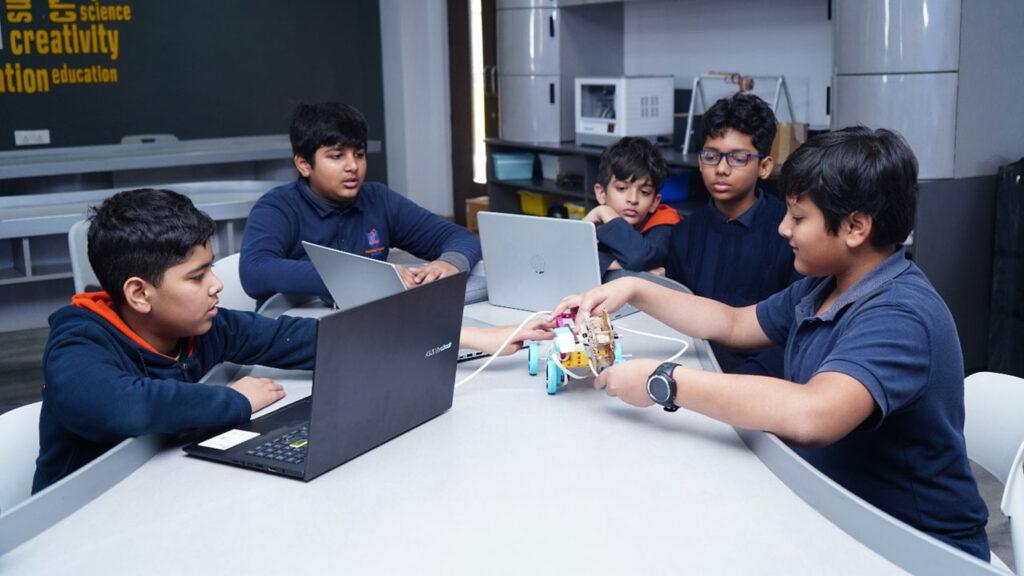 Prometheus School students collaborating on a robotics project in the lab