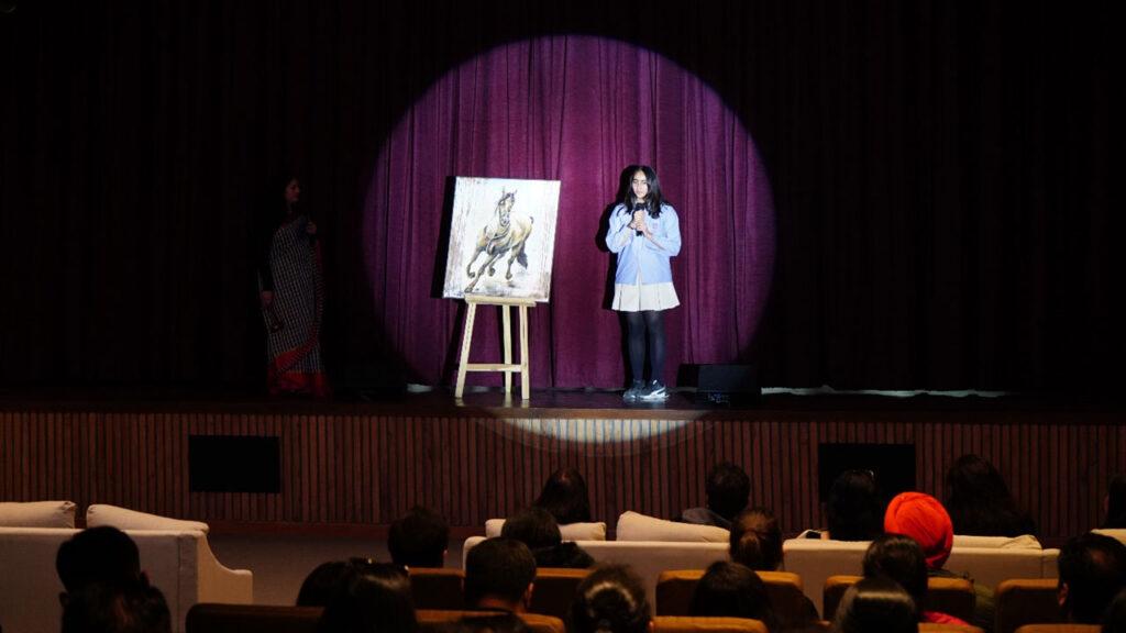 Secondary students showcasing their artwork on stage to all the parents