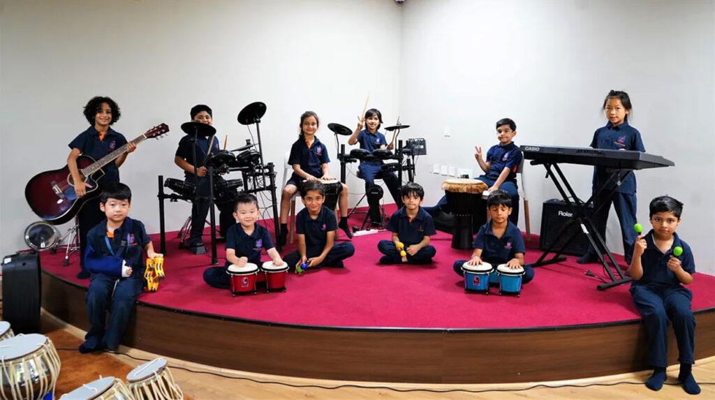 Primary school students are playing instruments and working in collaboration in the music studio at Prometheus School