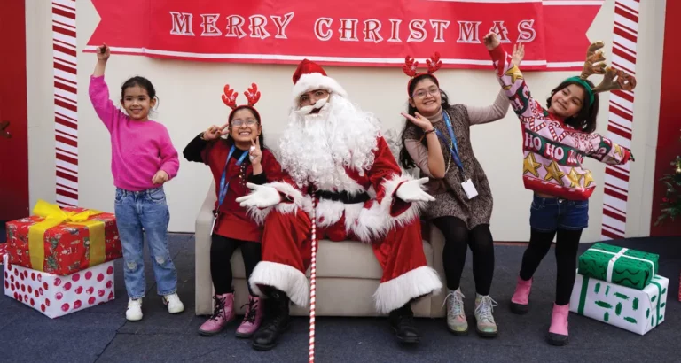 Santa Claus spreading joy, posing with cheerful students at the festive gathering. A heartwarming moment capturing the holiday spirit and excitement during the special event at the school.