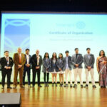 Members of the Interact Club captured with esteemed dignitaries, senior leadership, and the organizing committee