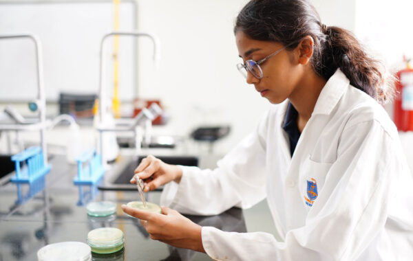Prometheus School student in the Science Lab is conducting an experiment, showcasing precision and focus while handling scientific equipment