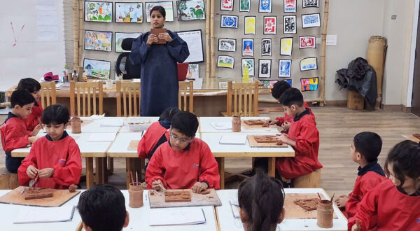 Prometheus School students attentively following their art teacher’s instructions while working on creative projects in a bright and inspiring classroom