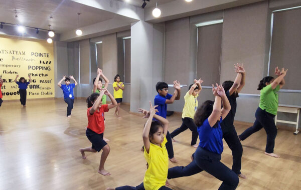 Prometheus-School-students-gracefully-striking-traditional-classical-dance-poses,-embodying-the-beauty-and-discipline-of-the-art-form