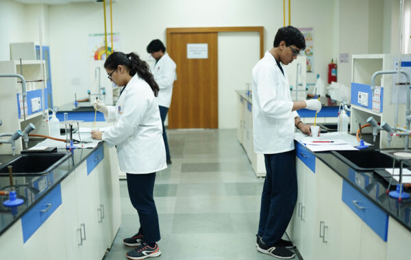 Prometheus School students working individually on lab experiments, engaging with various scientific tools and materials