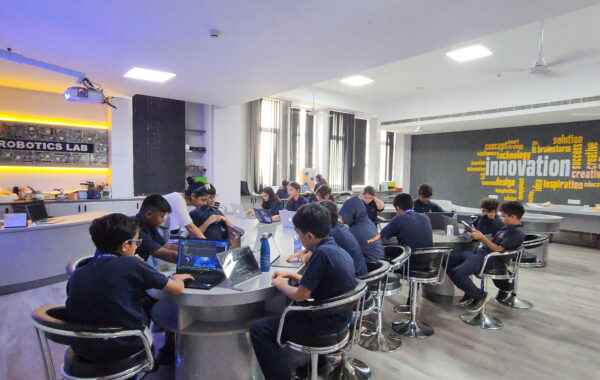 Prometheus School students working on laptops, engaged in programming and robotics tasks in the Secondary Robotics Lab