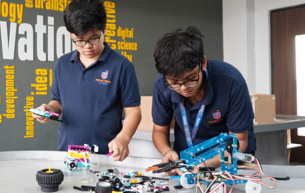students collaborating to design and construct a robot in the Secondary Robotics Lab at Prometheus School
