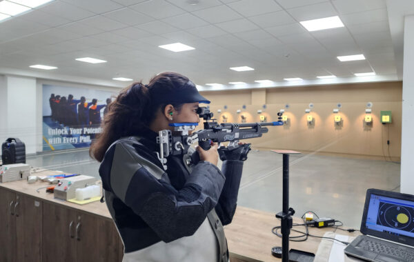 Rifle shooting practice: A Prometheus School girl, fully equipped in a professional shooting suit, practices rifle shooting at the range