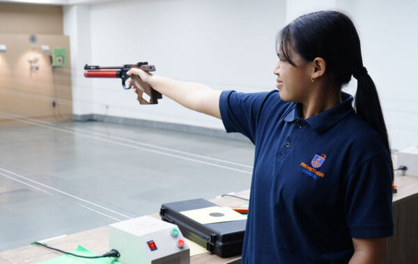 Dedicated practice: A Prometheus School girl hones her skills with focused pistol shooting practice at the range.