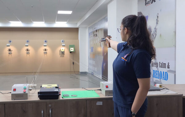 Focused aim: A Prometheus School girl performs pistol shooting with precision at the shooting range