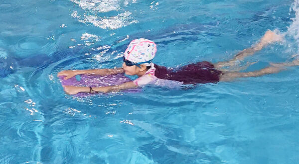 Learning in progress: A Prometheus School student practices and learns swimming techniques in the pool.