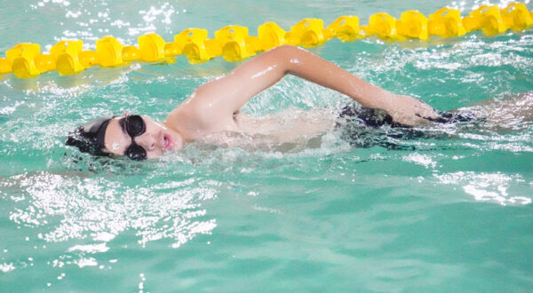 Focused technique: A Prometheus School student practices the butterfly stroke in the swimming pool with precision and energy.