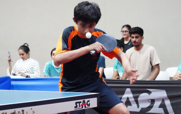 Backhand mastery-A Prometheus School student intensely focuses while performing a backhand shot