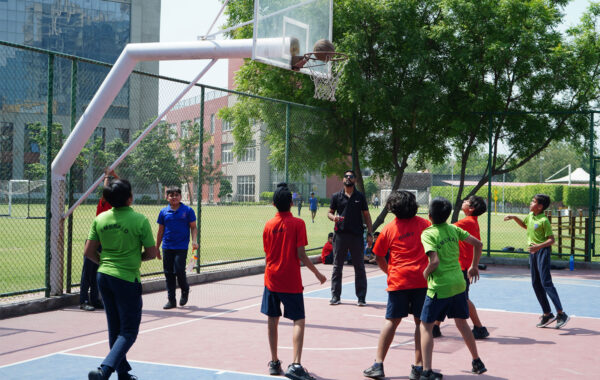 Emerald vs. Ruby rivalry-Emerald and Ruby house students display aggressive gameplay, showcasing a spirited rivalry during an exciting basketball match