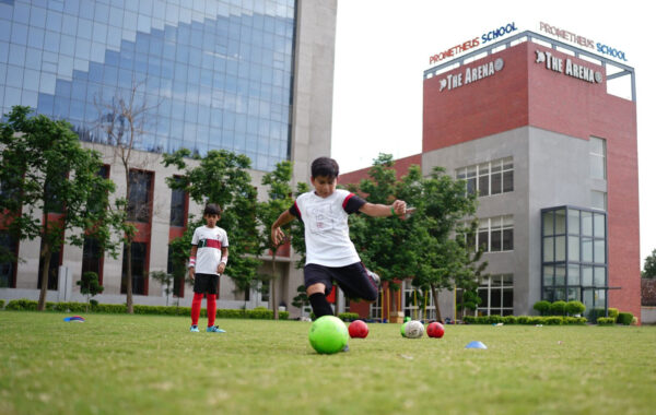 Rainy-day football-A Prometheus School student kicks the ball during a thrilling rainy-day football match in the competition