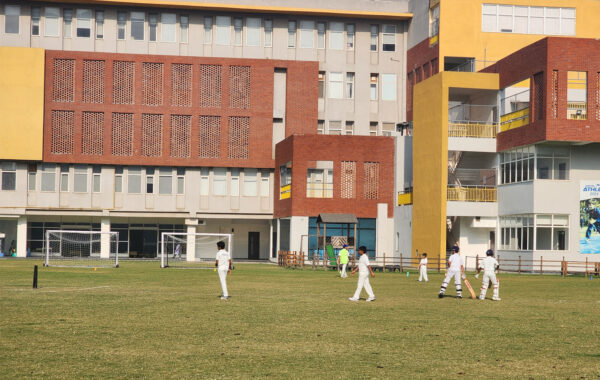 High-energy match-An intense cricket match unfolds at Prometheus School as players showcase aggressive and determined gameplay