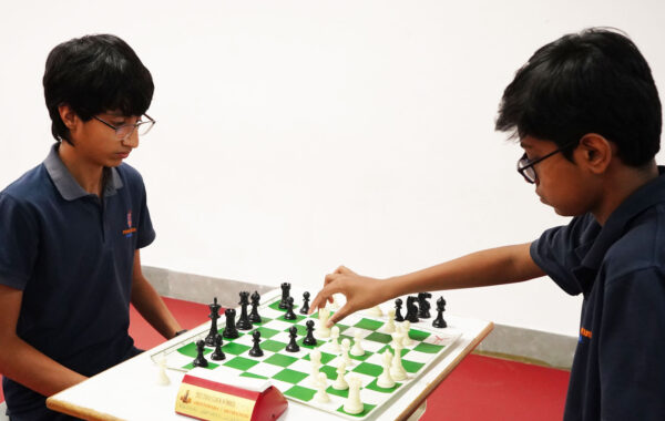 Prometheus School students are deeply focused while playing chess, striving to outthink and defeat each other