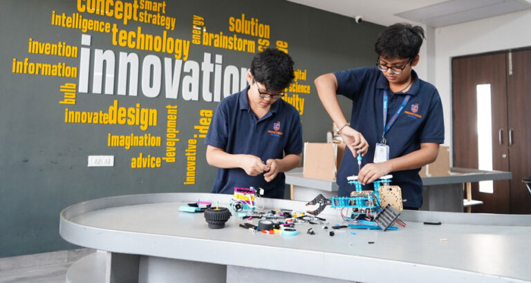 Innovative Robotics in Action – Prometheus School students collaborate in the robotics lab, assembling and programming a robot, showcasing their creativity and problem-solving skills