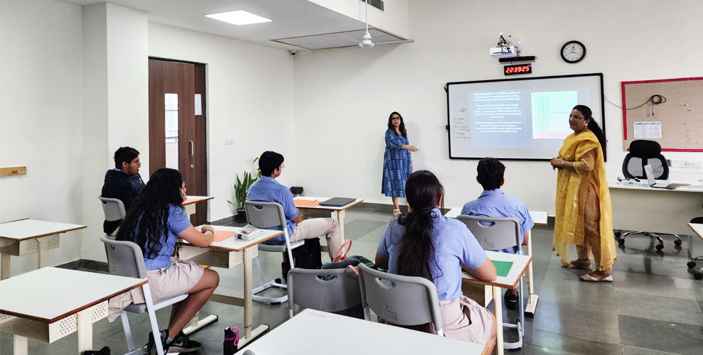 Prometheus school engaging classroom Learning – A teacher passionately explains a concept to students in a well-equipped classroom, fostering an interactive and dynamic learning environment