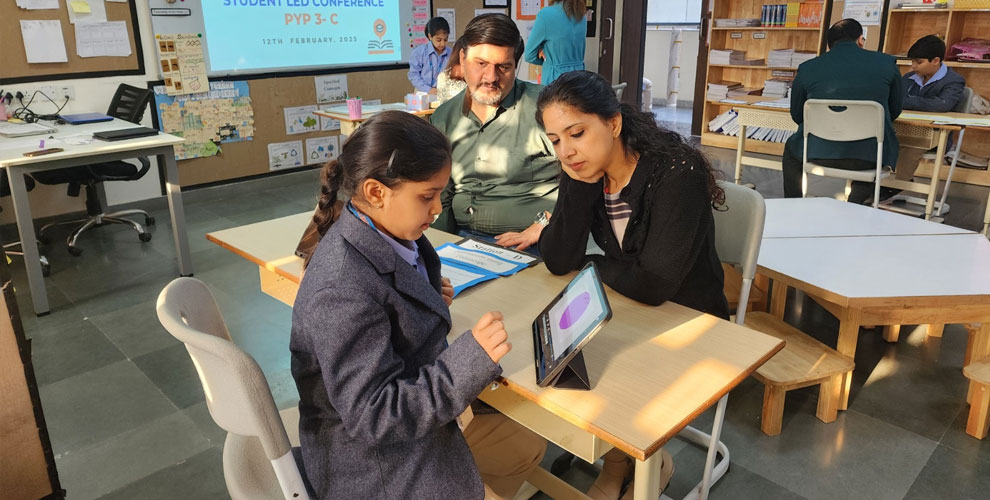Showcasing Knowledge with Confidence – A Prometheus student passionately presents her project and research work to a parent during the Student-Led Conference, demonstrating understanding, creativity, and communication skills.
