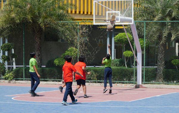 Emerald vs Ruby scoring-Emerald and Ruby house students compete fiercely as they attempt to score a basket during the interhouse basketball match