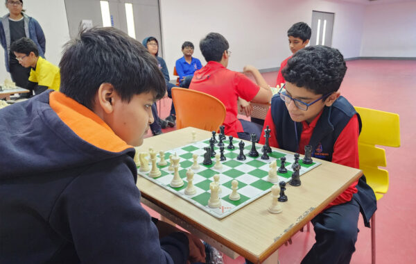 Students playing chess are deeply engrossed, carefully contemplating their next moves to outwit their opponents