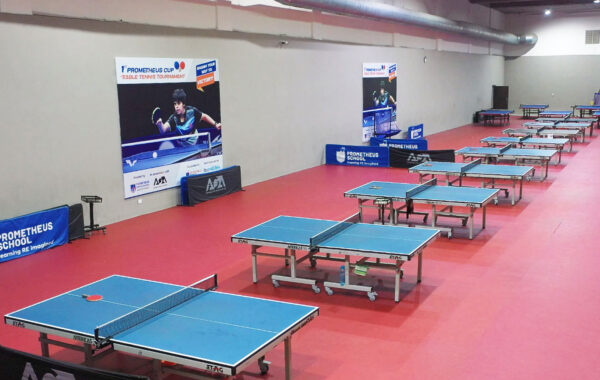 Wide perspective-An aerial view of the table tennis court at Prometheus School, displaying multiple tables in action