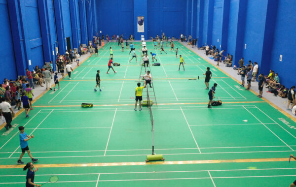 Wide top-angle view of badminton court-A bird's-eye view showcasing the Prometheus School badminton court, with clear visibility of the boundaries, nets, and players in action